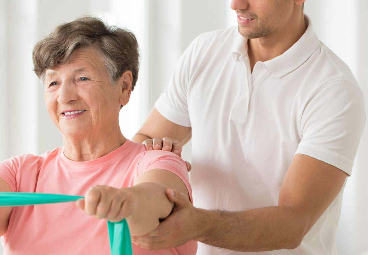 Physiotherapist assisting patient